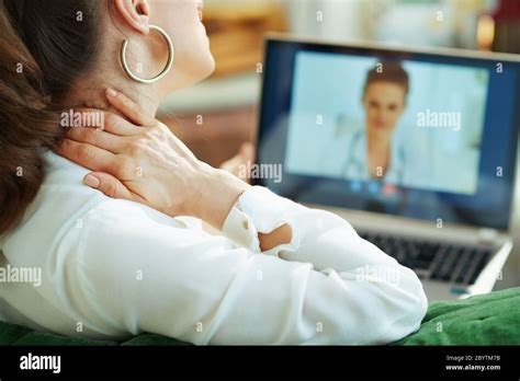 Seen From Behind Woman In White Blouse With Neck Pain Speaking With