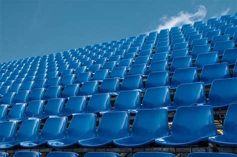 Premium Photo Low Angle View Of Empty Blue Chairs Against Sky