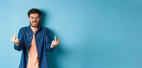 Premium Photo Angry Rude Guy Showing Middle Finger And Saying Fuck You Swearing And Staring