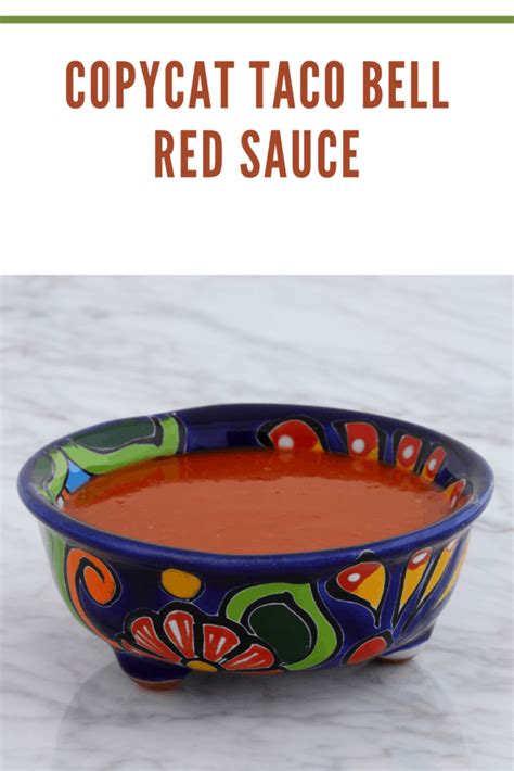 a colorful bowl filled with red sauce on top of a white counter next to ...