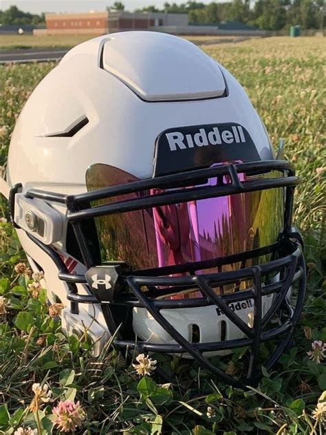 A Helmet Sitting In The Grass On Top Of A Field