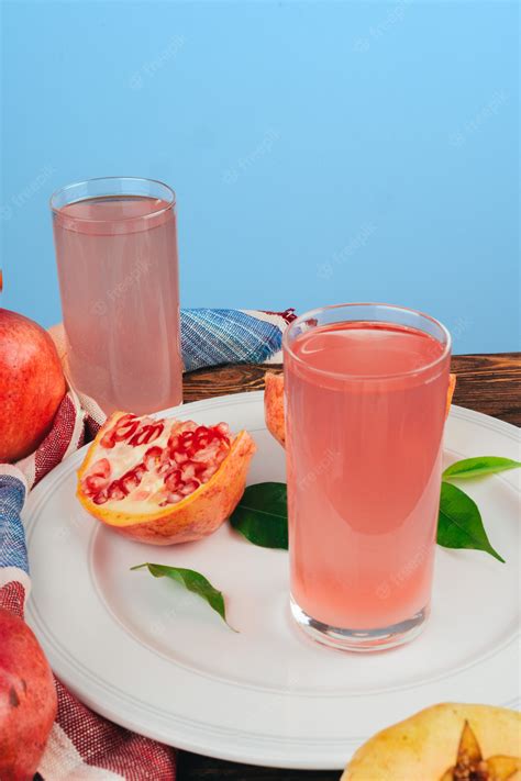 Premium Photo Glass Of Pomegranate Juice And Fruits On A Table