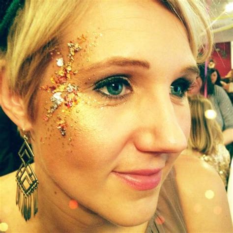 A Close Up Of A Person With Glitter On Their Face