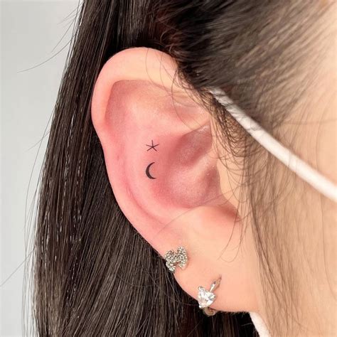 Tiny Moon And Star Tattoo Located On The Ear