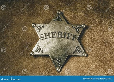 Sheriff Badge On Brown Leather Texture Background Stock Image