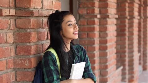 Video Clip Of A Teenage Indian College Girl Carrying A Backpack And Holding Books 16885781