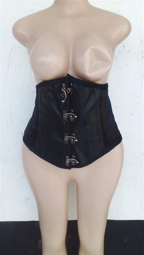 A Female Mannequin Wearing A Black Leather Corset