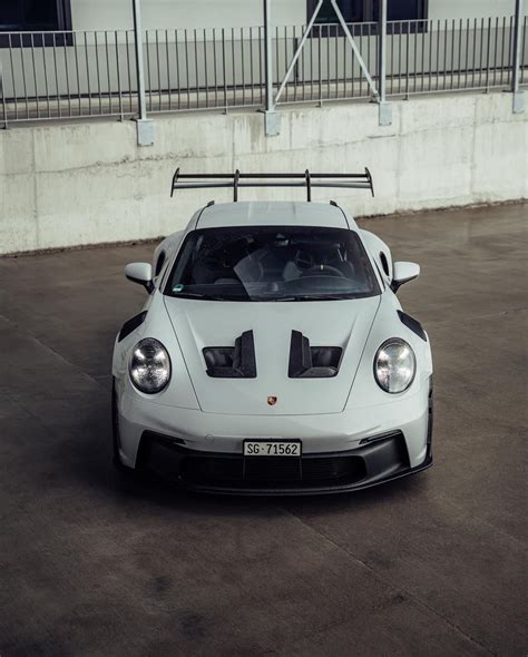 White Sports Car Parked In Front Of Building