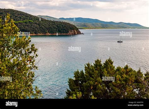 Two Yahts Floating Near The Scenic Landscape Of Cala Violina Beach In