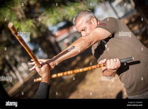 Escrima And Kapap Instructor Demonstrates Sticks Fighting Techniques