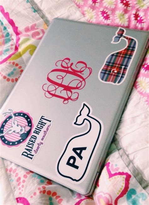 a book sitting on top of a bed covered in pink and blue sheets with stickers