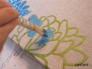 Someone Is Using A Brush To Paint The Fabric With Blue And Green