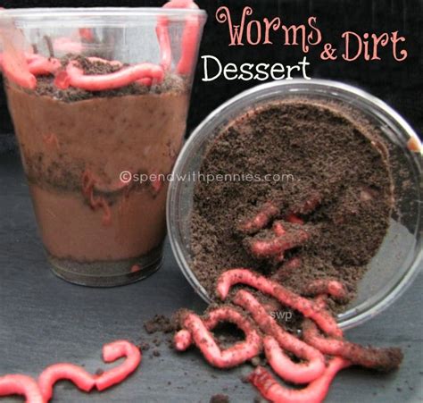 worms and dirt dessert next to a cup