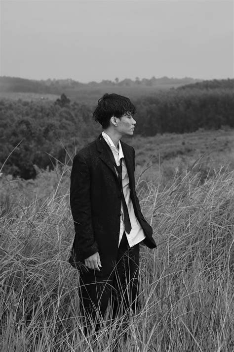 Elegant Man Standing Alone In A Grassy Field · Free Stock Photo