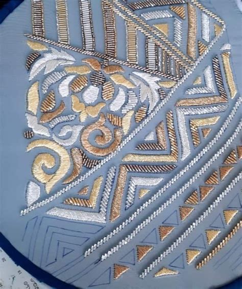 A Blue Plate With Gold And White Designs On It