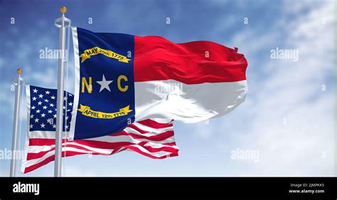 The North Carolina State Flag Waving Along With The National Flag Of