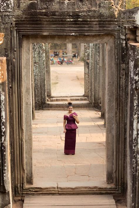 Cambodian Girl In Khmer Dress Standing In Bayon Temple In Angkor City