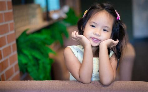 Premium Photo Portrait Of Cute Girl Sitting Outdoors