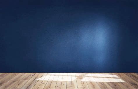 An Empty Room With Blue Walls And Wooden Floors