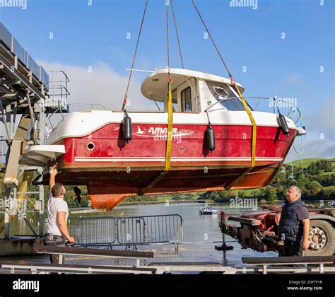 Two Men Guiding Crane Lifting Boat Hi Res Stock Photography And Images