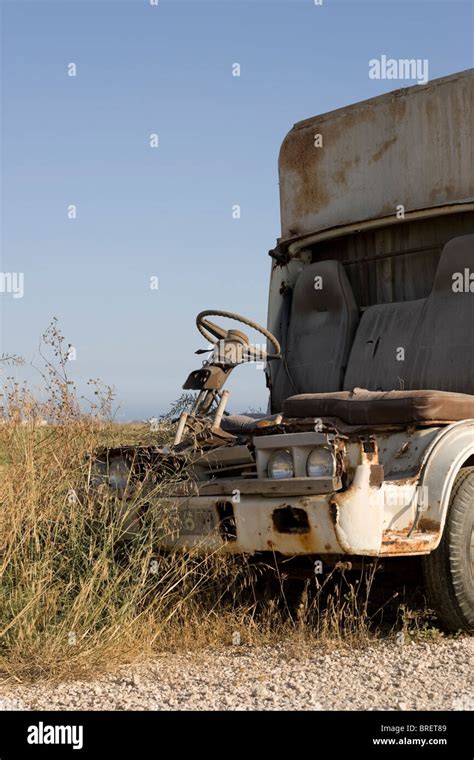 An Old Broken Down Van Left To Rust On A Dusty Road In Cyprus Stock