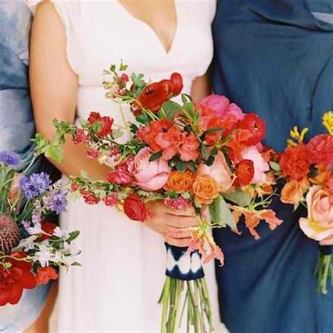 Two Women Holding Bouquets Of Flowers In Their Hands