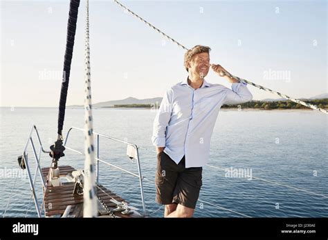 Portrait Of Smiling Mature Man On His Sailing Boat Stock Photo Alamy