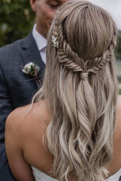 A Man And Woman Standing Next To Each Other With Long Hair In Braids On