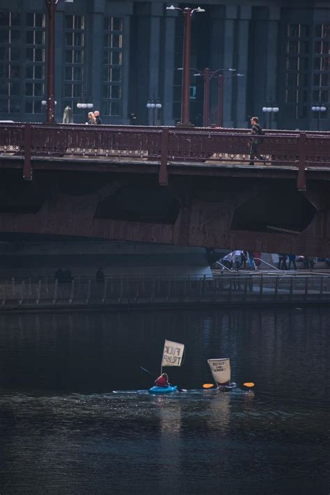 Free Stock Photo Of Two Kayakers Protest With Signs On River Under