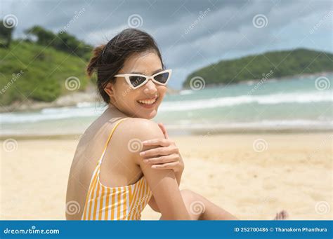 Young Beautiful Woman In Bikini Enjoying And Relaxing On The Beach