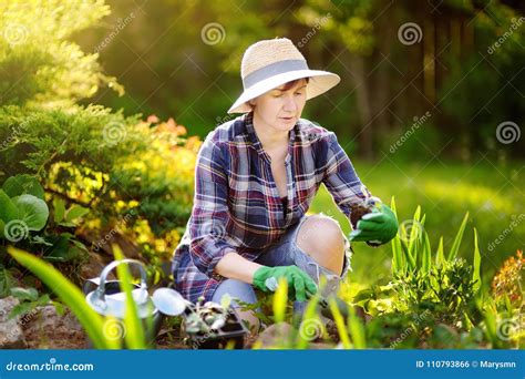 Portrait Of Smiling Beautiful Middle Age Female Gardener Stock Photo