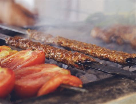 Traditional Turkish Adana Kebab Or Kebap On The Grill With Skewers In