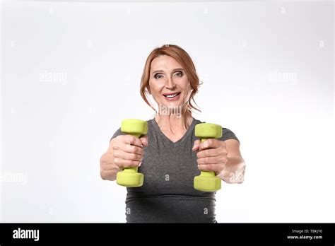 Sporty Mature Woman With Dumbbells On White Background Stock Photo Alamy