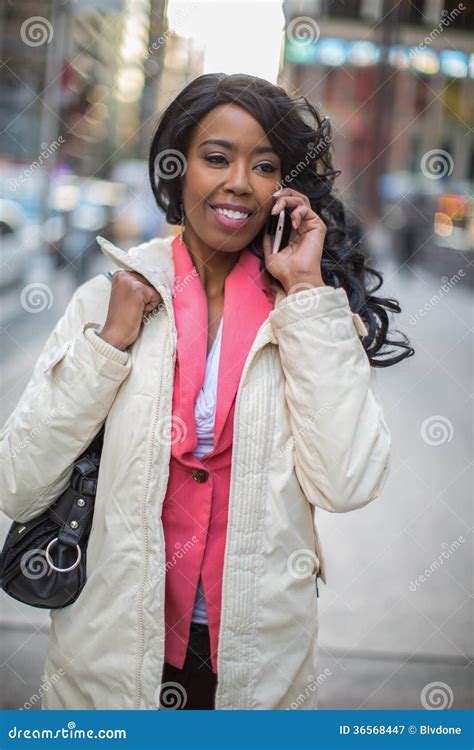 Black African American Woman Talking Cellphone In City Stock Image