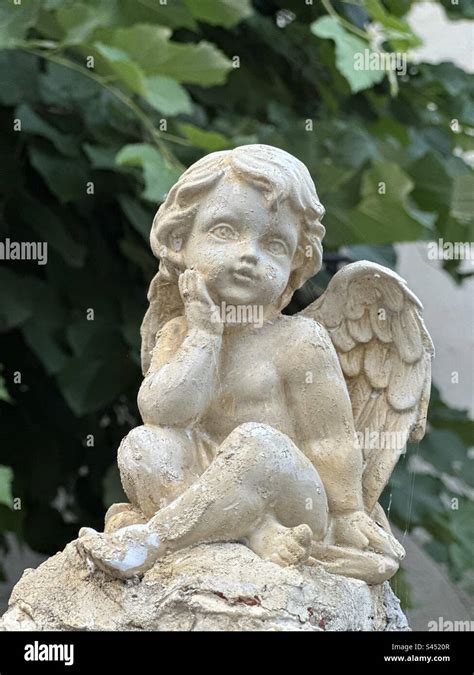 Stone Statue Of A Sitting Angel Stock Photo Alamy