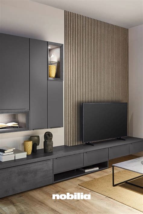 A Modern Living Room With Grey Cabinets And A Flat Screen Tv