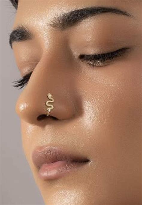 A Close Up Of A Woman S Nose With A Gold Nose Ring On It