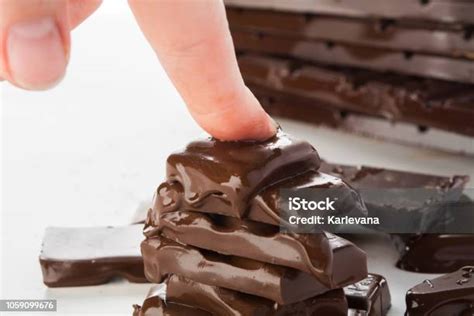 Woman Hand Is Pressing Melting Stack Of Chocolate Hate Chocolate