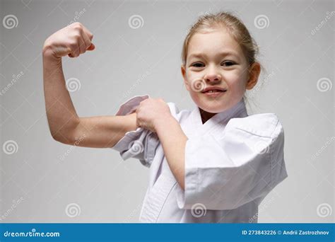 Portrait of a Little Girl Showing Biceps. Muscle and Endurance Training ...