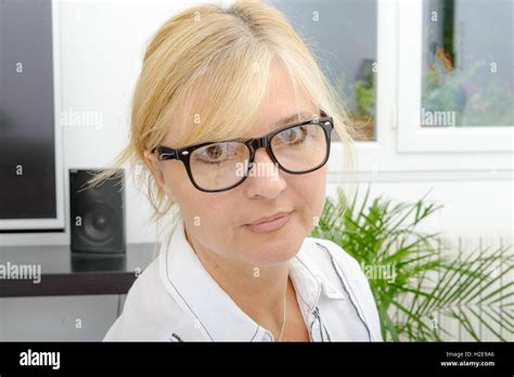 Portrait Of Smiling Mature Blond Woman With Eyeglasses Stock Photo Alamy