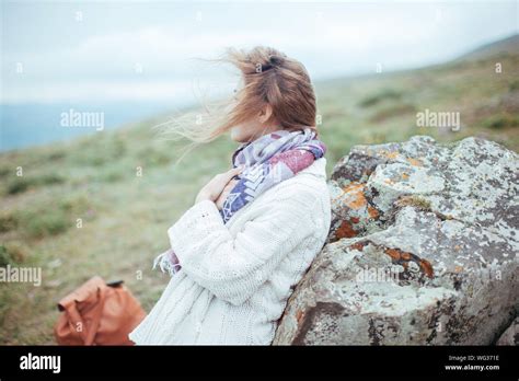 Woman Leaning Against Rock Stock Photo Alamy