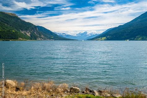 View Of Lake Resia German Reschensee And Ortler Mountains In Val