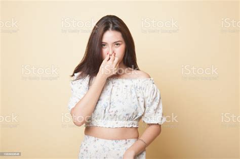 Young Asian Woman Holding Her Nose Because Of A Bad Smell Stock Photo