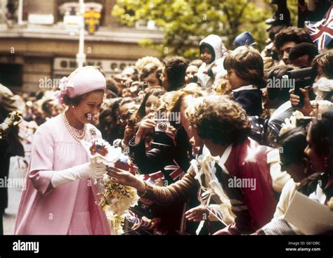 Queen Elizabeth Ii Accepts A Posy Of Flowers From A Well Wisher During