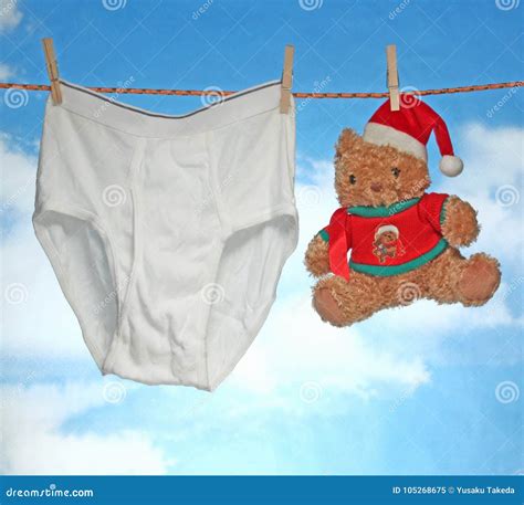Male Pants Hanging On A Clothes Hanger Inside A Clothing Store Stock