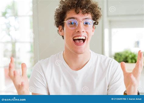 Young Handsome Man Wearing Glasses Celebrating Crazy And Amazed For