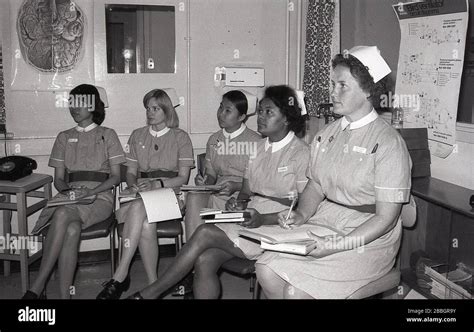 1970s Historical Uniformed Nurses With Notebooks Sitting In A Meeting