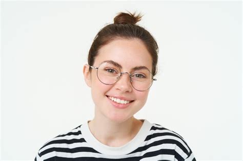 Retrato em close up de uma jovem bonita de óculos olhando para a câmera