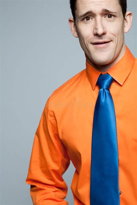 Happy Man In Orange Shirt And Blue Tie Stock Image Image Of