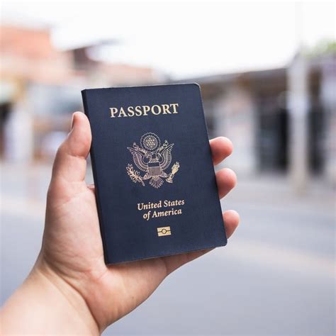 American Traveler Holding Up A Us Passport Travel Off Path